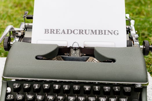 Close-up of a vintage typewriter outdoors with paper reading 'BREADCRUMBING'.